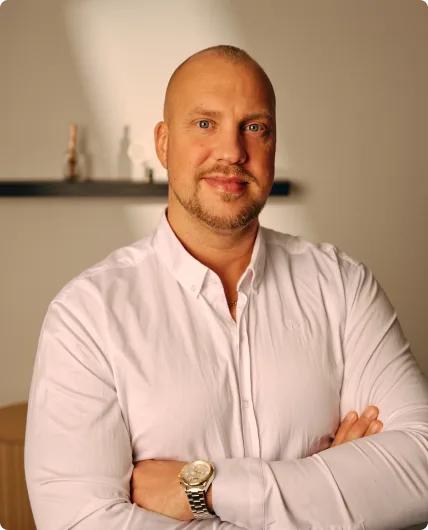 Bald man wearing white long-sleeve button-up shirt with gold watch
