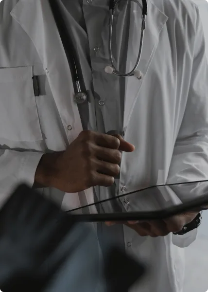 Doctor in a white coat holding a tablet